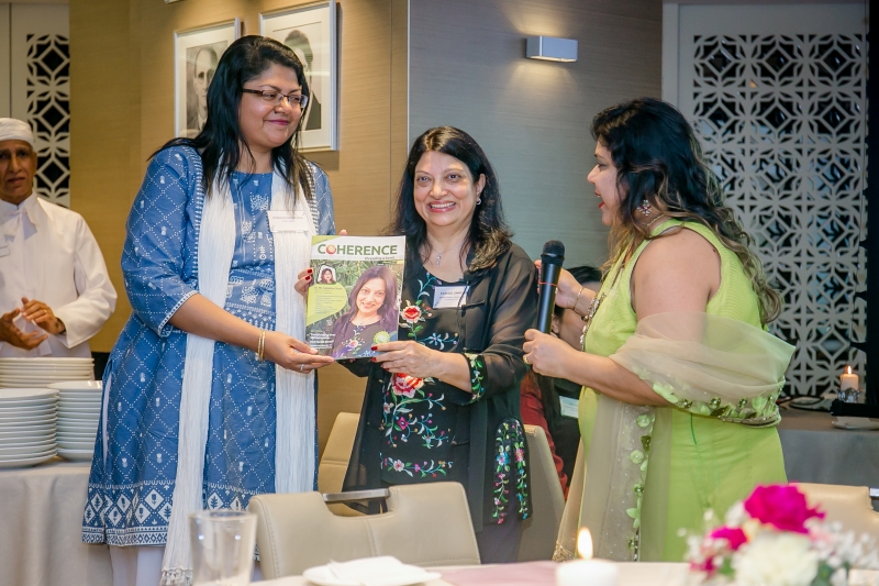Faride Shroff holding a magazine in which she is featured on the front page whilst being interviewed