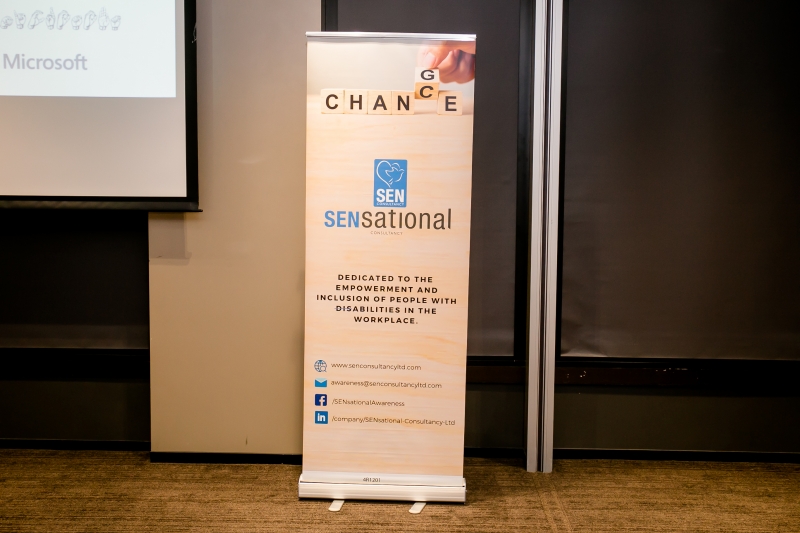 A SENsational Foundation banner saying Chance for Change is set up at the font next to the projecter